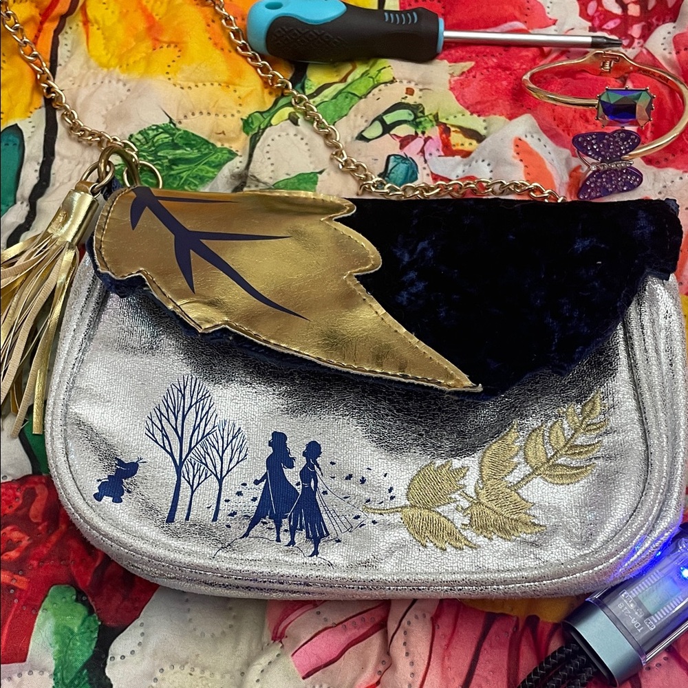 Disney Silver Metallic Crossbody Bag with Gold Leaf Accent and Navy Flap.
